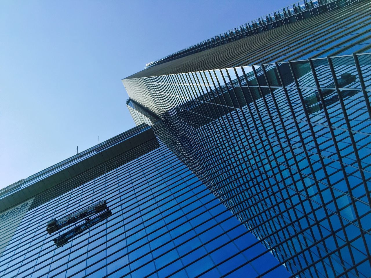 low angle view, building exterior, architecture, built structure, clear sky, blue, modern, tall - high, office building, tower, skyscraper, city, building, day, sky, outdoors, no people, glass - material, sunlight, architectural feature