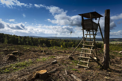 Lifeguard hut on field against sky