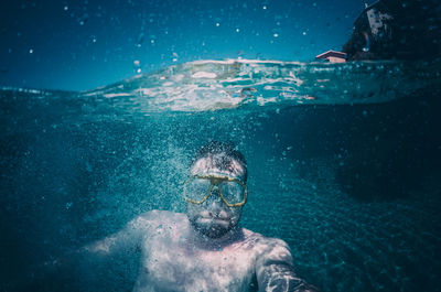 Portrait of man swimming in pool