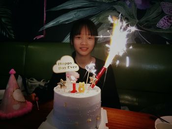 Portrait of woman with cake during birthday