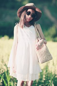 Woman wearing sunglasses standing on field