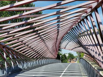 Low angle view of footbridge against sky