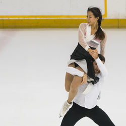 Full length of couple dancing on ice rink