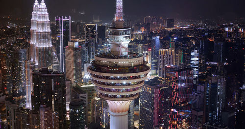 Aerial view of illuminated buildings in city at night