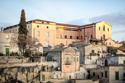 Buildings in town against sky