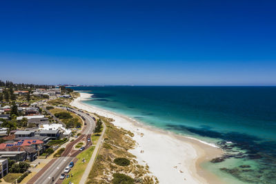 Scenic view of beach against blue sky