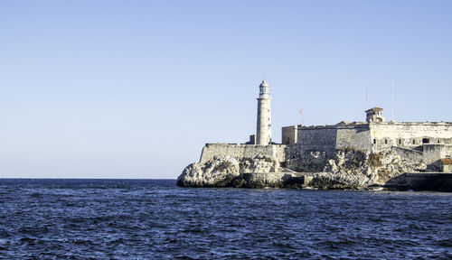 Morro castle by sea against clear sky