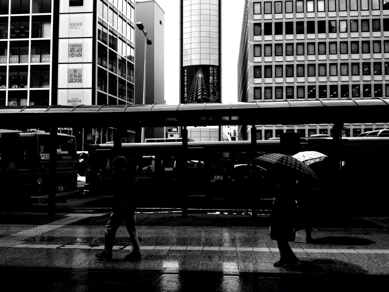 building exterior, architecture, built structure, walking, city, street, lifestyles, men, city life, full length, person, leisure activity, transportation, building, city street, rear view, silhouette, on the move