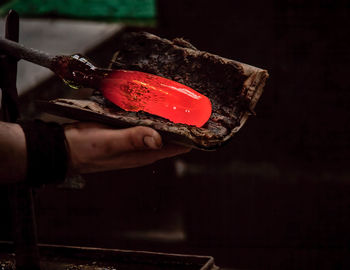 Close-up of hand working in glass factory