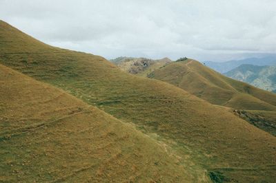 Scenic view of sand dunes against sky