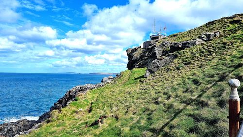 Scenic view of sea by buildings against sky