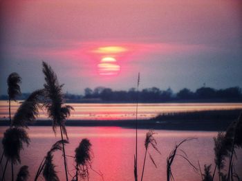 Scenic view of lake against romantic sky at sunset