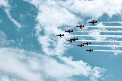 Low angle view of airshow against sky