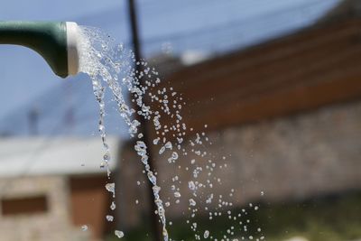 Close-up of water drop falling on fountain