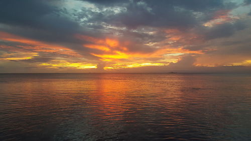 Scenic view of sea against romantic sky at sunset