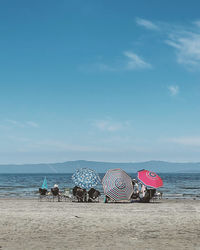 A day at the beach under sun umbrellas