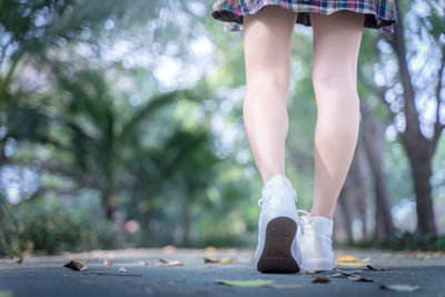 Low section of woman wearing shoes outdoors