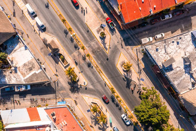 Aerial view of the street intersection with cars driving down the road.