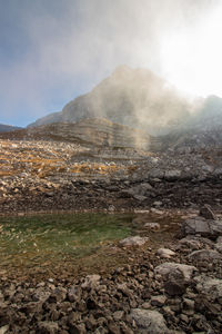 Smoke emitting from volcanic mountain against sky