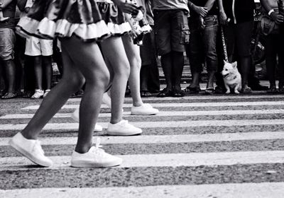 Low section of people walking on road