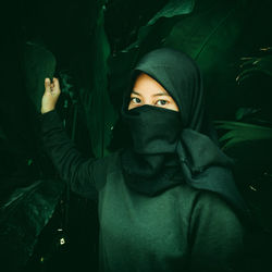 Veiled woman with a dark green effect