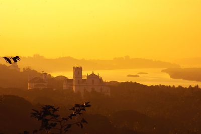 Scenic view of buildings against sky during sunset