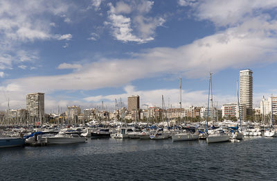 Boats moored in sea against sky