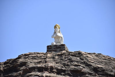 Low angle view of statue against clear blue sky