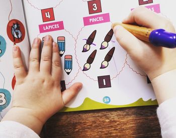 Midsection of woman holding paper with text