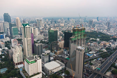 High angle view of modern buildings in city against sky