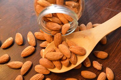 High angle view of almonds spilling on table