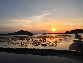 Scenic view of lake against sky during sunset