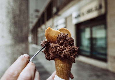 Close-up of hand holding ice cream cone