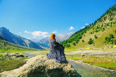 Man standing on mountain against sky