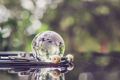 Close-up of crystal ball on glass table