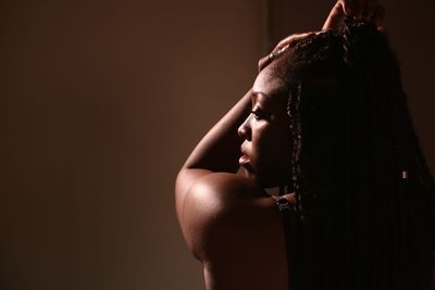 Rear view of woman against brown background