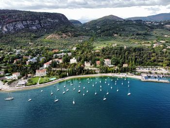 High angle view of sea and mountains against sky