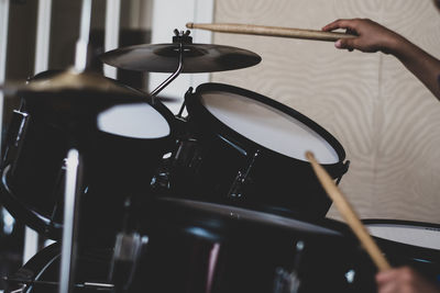 Cropped hands playing drum