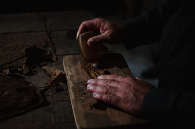 Midsection of man preparing food on table