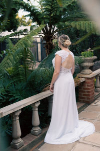 Rear view of woman standing by plants