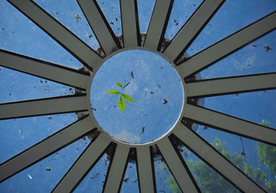 Low angle view of metallic structure against blue sky