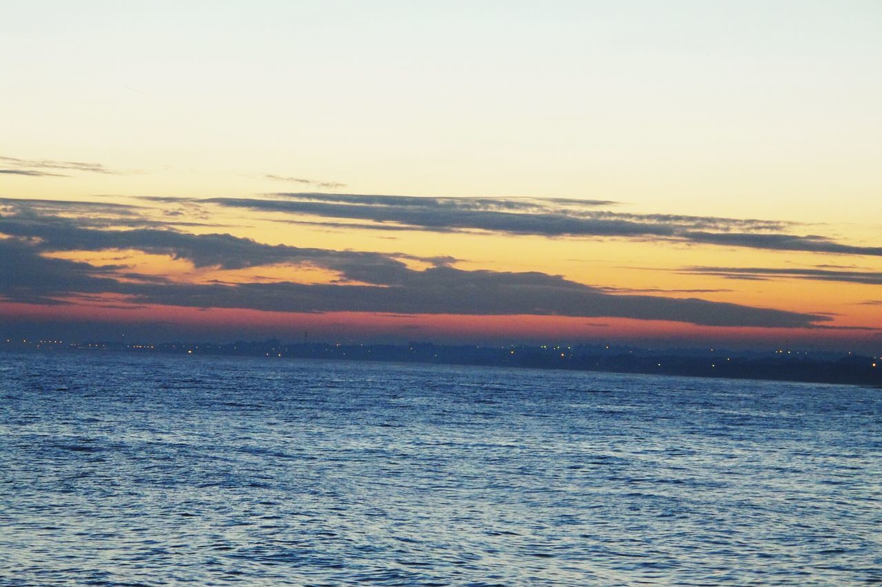 water, sea, tranquil scene, scenics, waterfront, tranquility, sunset, beauty in nature, sky, horizon over water, nature, idyllic, rippled, seascape, cloud - sky, outdoors, no people, cloud, orange color, remote