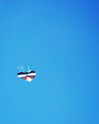 Low angle view of helicopter flying in sky