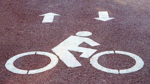 High angle view of arrow sign on road