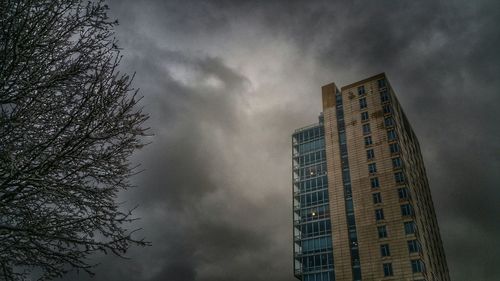 Low angle view of building against cloudy sky