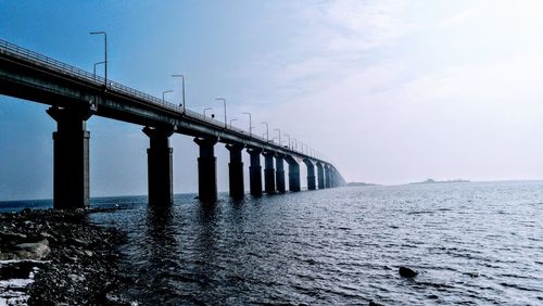 Bridge over sea against sky