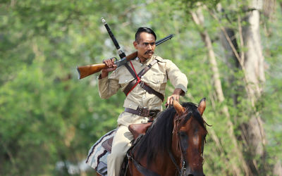 Senior man riding horse