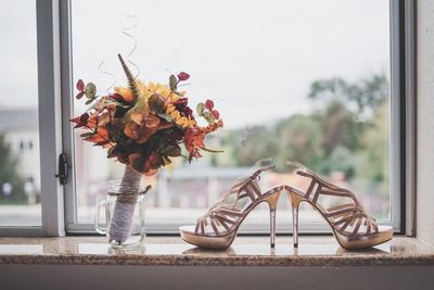 Close-up of flower vase on window sill