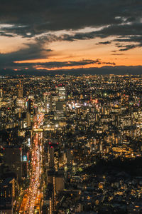 High angle view of illuminated cityscape against sky at night