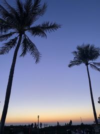 Silhouette palm trees against sky during sunset